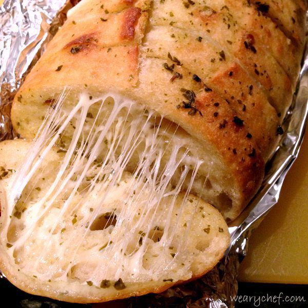 Irresistible Cheesy Pesto Bread - This cheesy garlic bread recipe is easy to make and will impress your friends and family!