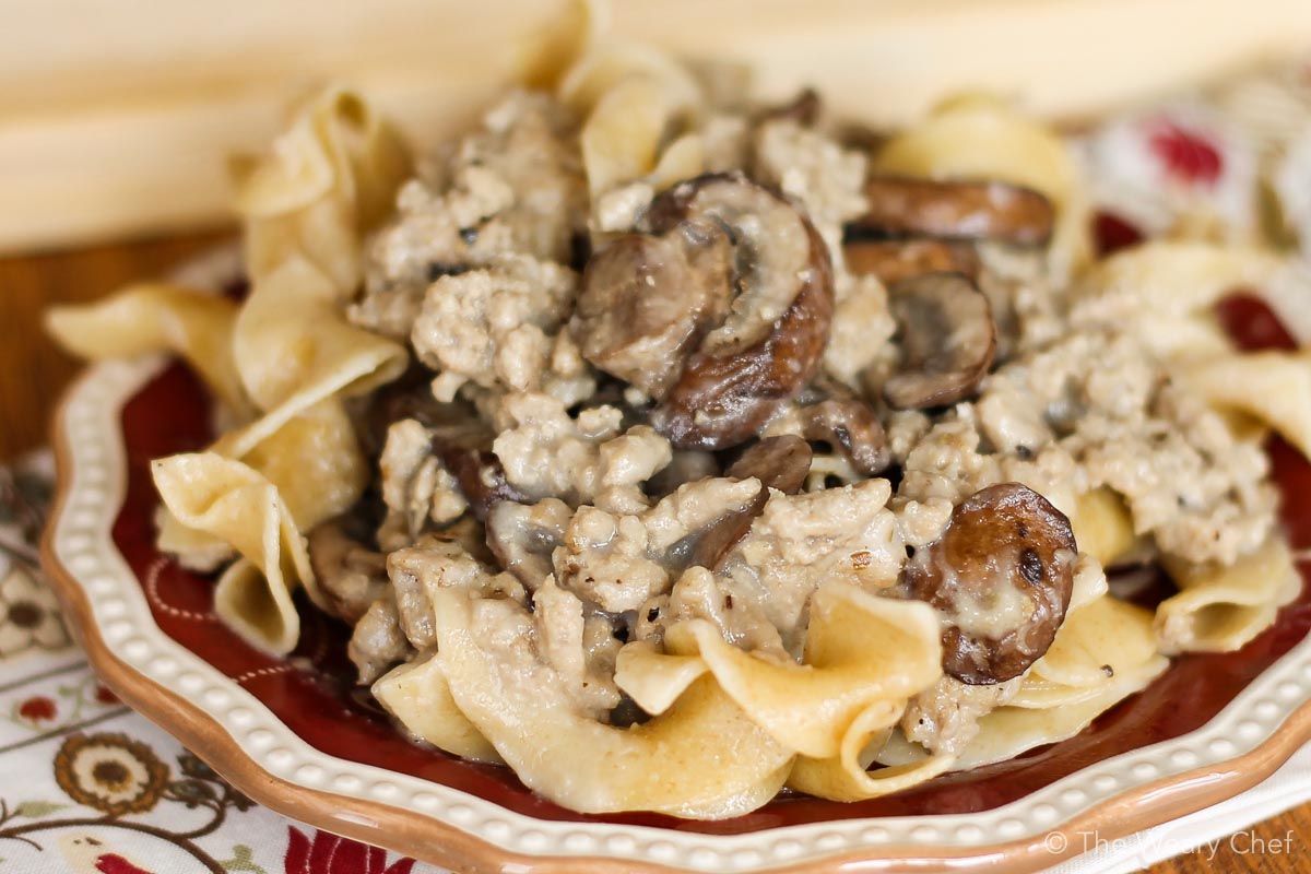 Your family will love this hearty, creamy ground beef stroganoff served over egg noodles. You will love that it's made from scratch and still ready in under 30 minutes. #stroganoff #groundbeef #easydinner #easyrecipe #thewearychef