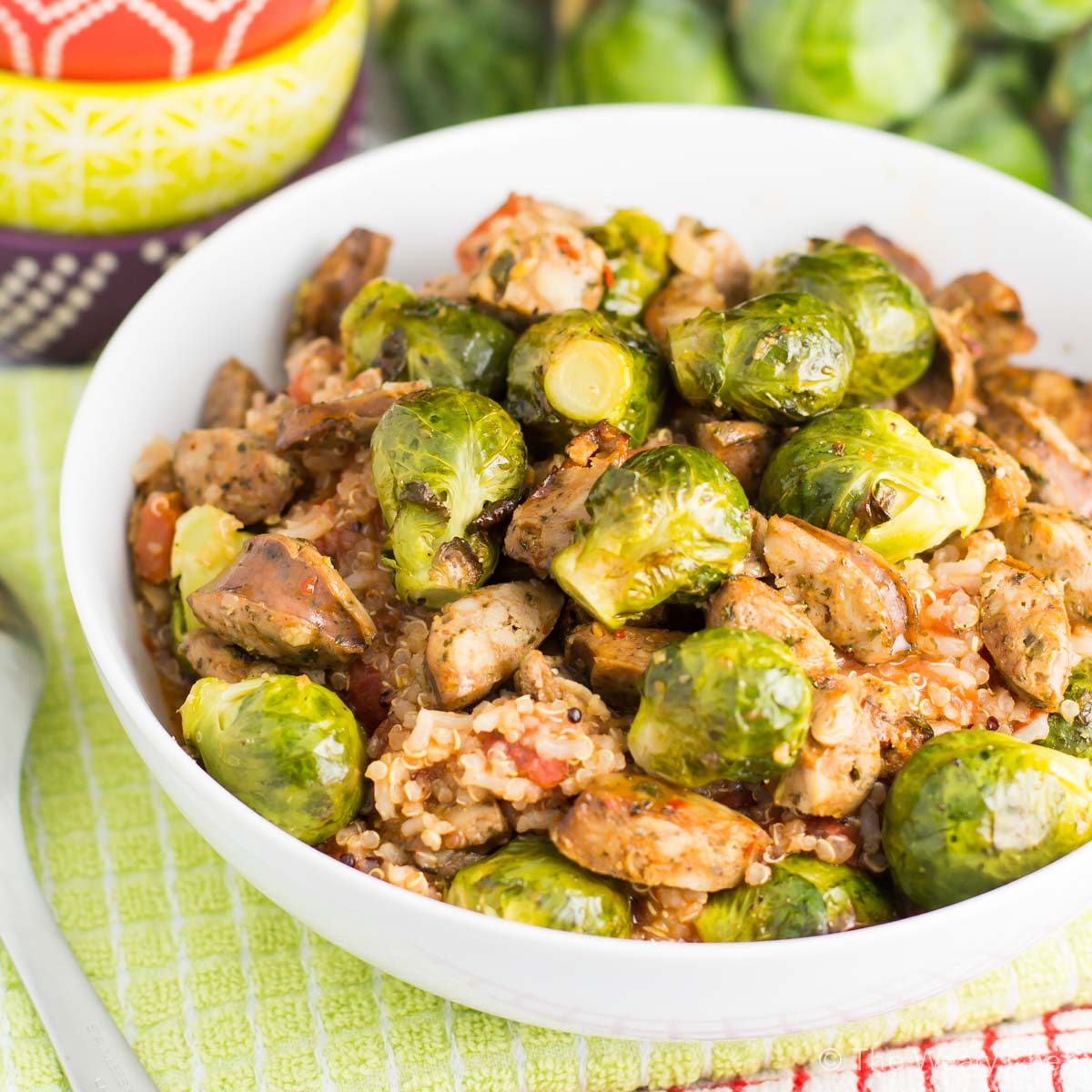 Dig into this fast, delicious, healthy quinoa recipe for dinner! It's loaded with tomatoes, sausage, and brussels sprouts to fill you up in a wholesome way.