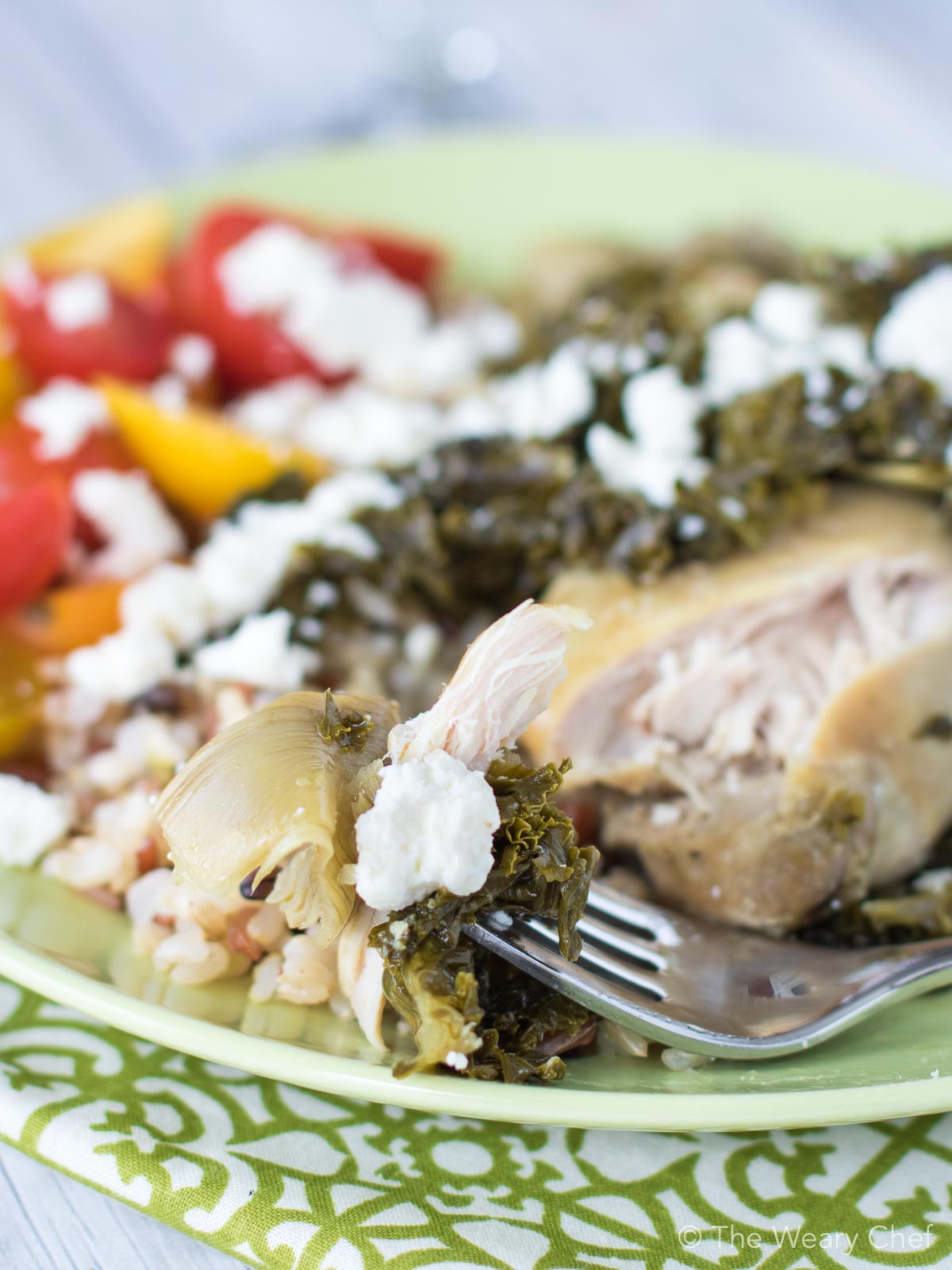 Enjoy these slow cooker chicken thighs simmered with seasoned artichokes, vermouth, and fresh kale. 