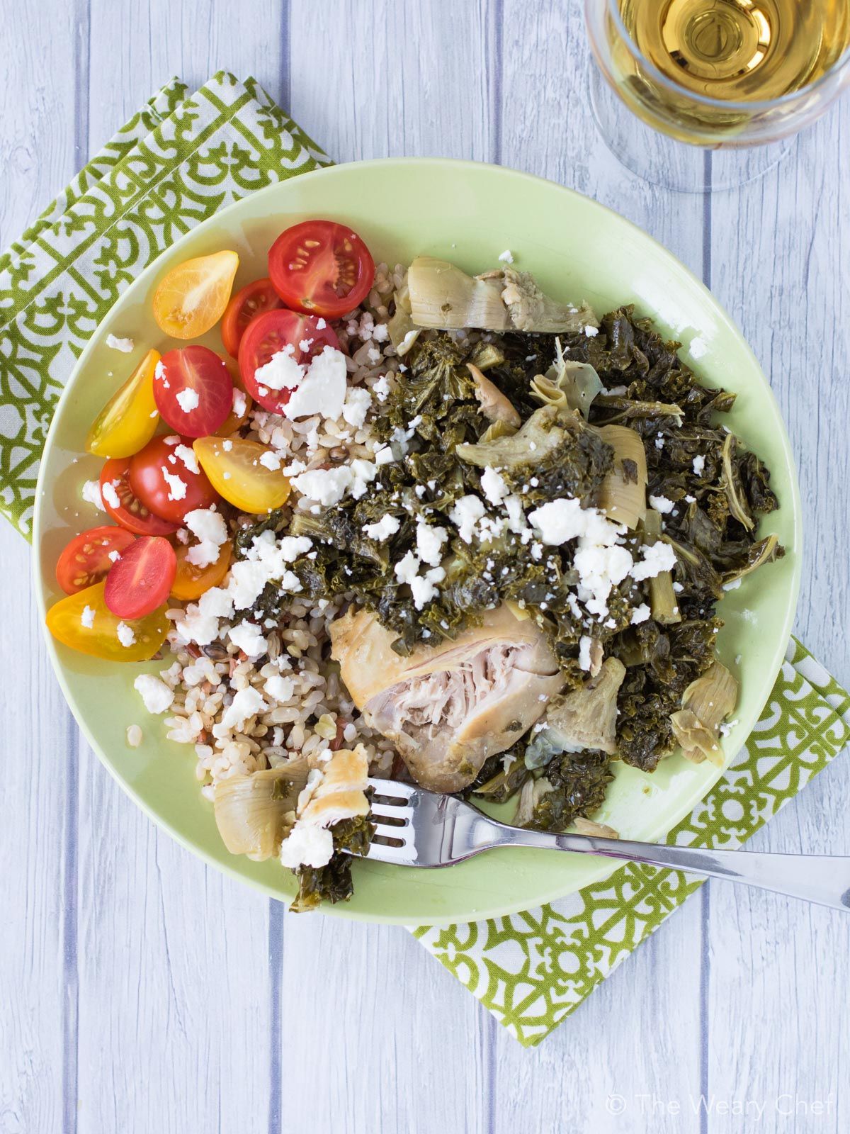 You'll love these slow cooker chicken thighs simmered with seasoned artichokes, vermouth, and fresh kale. 