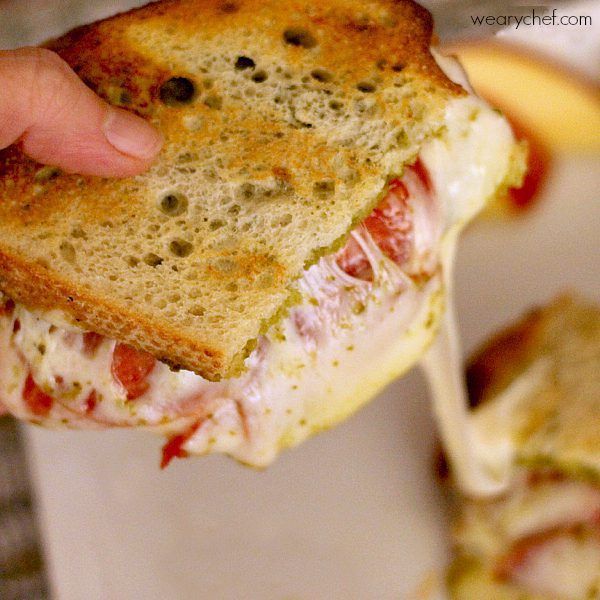 These savory pesto grilled cheese sandwiches with tomatoes and pepperoni are simple to make and incredibly satisfying!