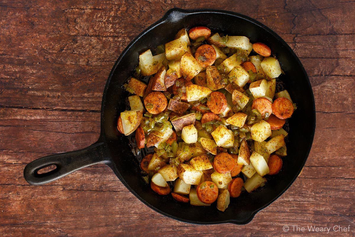 Baked Eggs over Roasted Potatoes and Sausage makes a perfect meal any time of day! #eggs #sausage #potatoes #breakfast