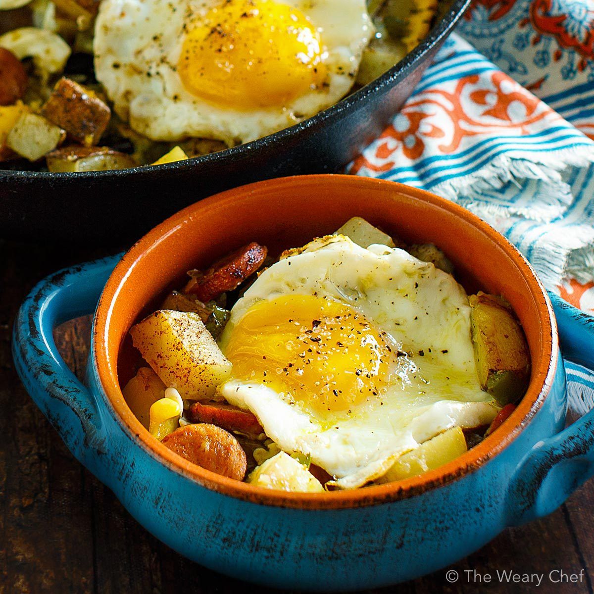 Baked Eggs over Roasted Potatoes and Sausage makes a perfect meal any time of day! #eggs #sausage #potatoes #breakfast