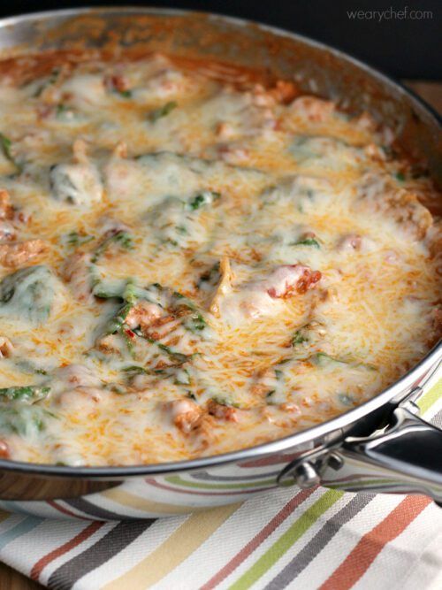 This shortcut lasagna recipe is loaded with tomatoes, ground sausage, spinach, and noodles, all under a blanket of melted cheese. It's ready in under 30 minutes for a great weeknight dinner!