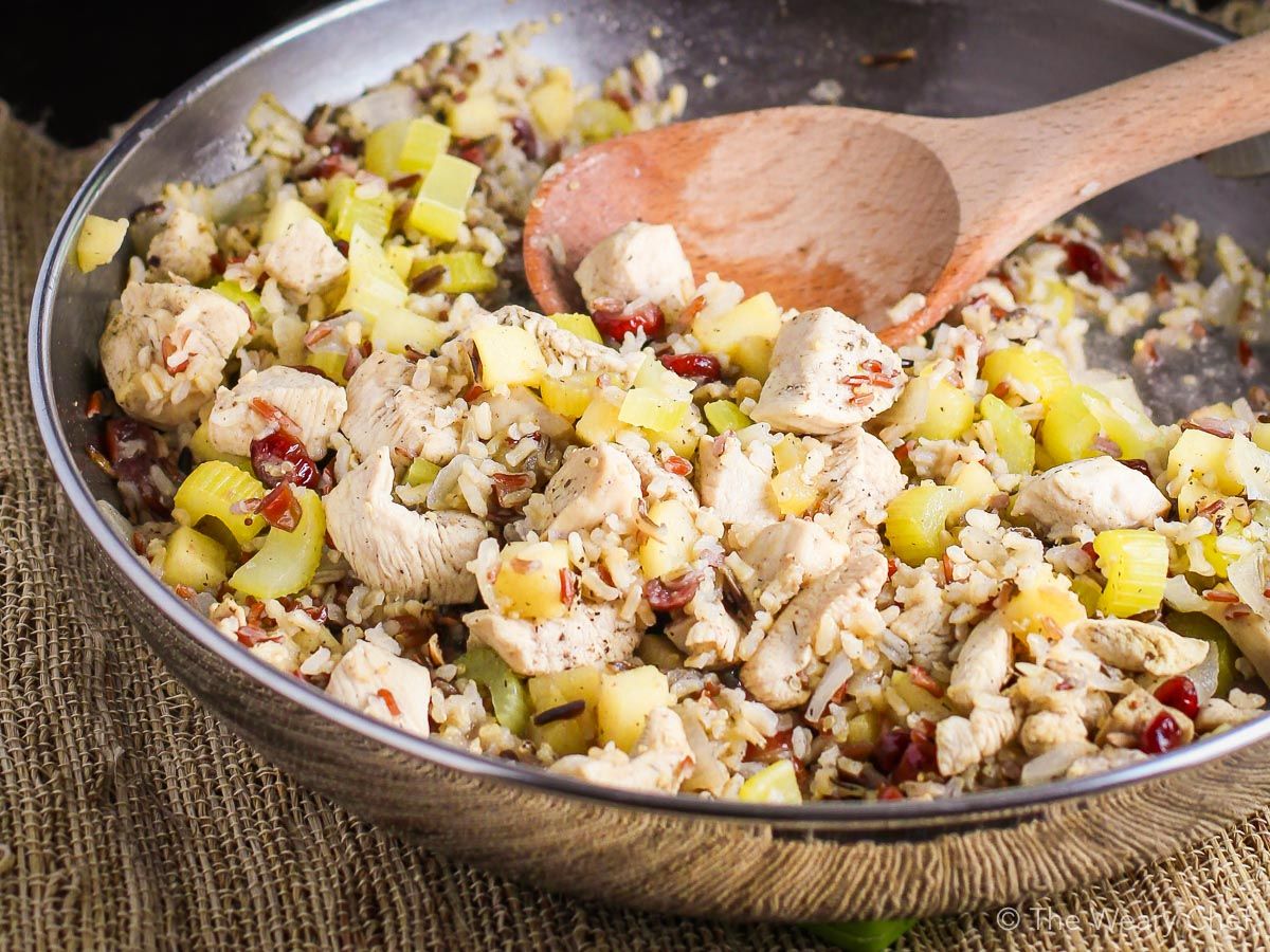 This 30-minute skillet dinner is loaded with dried cranberries, fresh apples, celery, and chicken simmered together with instant brown rice. #cranberry #apple #chicken #rice