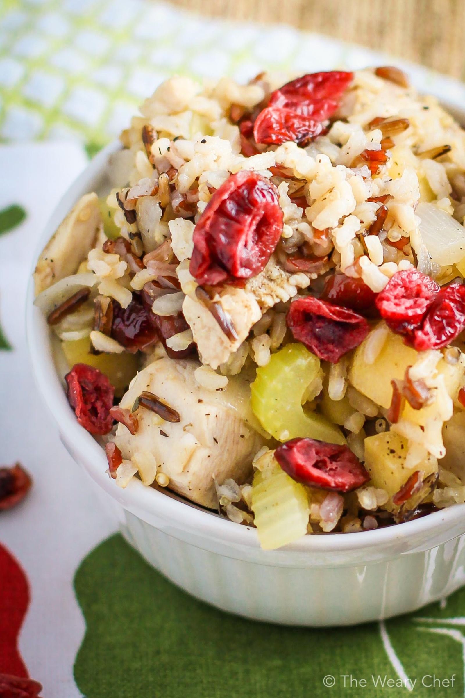 This 30-minute skillet dinner is loaded with dried cranberries, fresh apples, celery, and chicken simmered together with instant brown rice. #cranberry #apple #chicken #rice