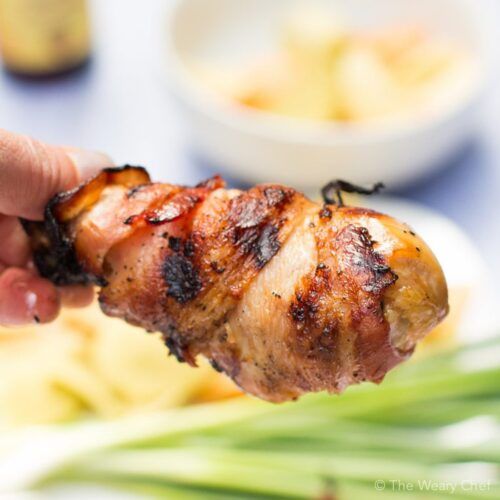 Easy bacon-wrapped chicken drumsticks are flavored with honey, soy, and Sriracha!