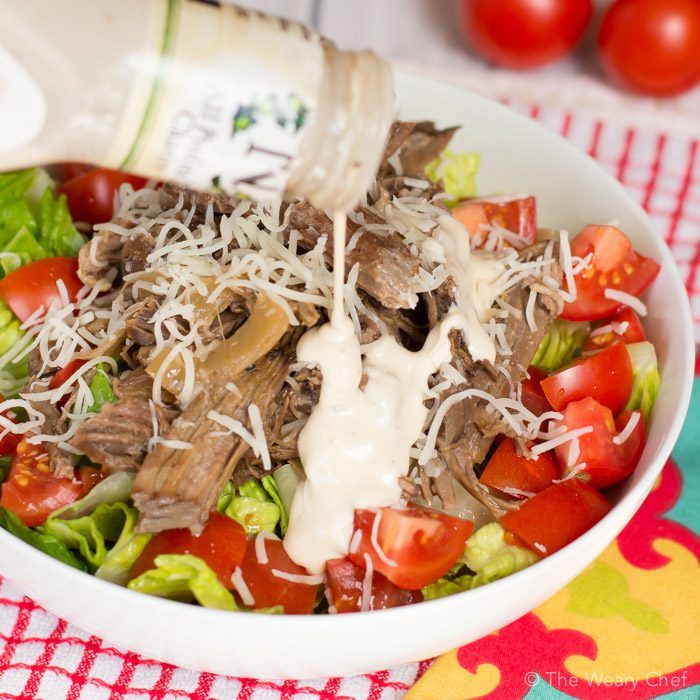 Slow cooker beef loaded with caesar flavor is served on a bed of healthy greens. Super easy, versatile weeknight dinner!