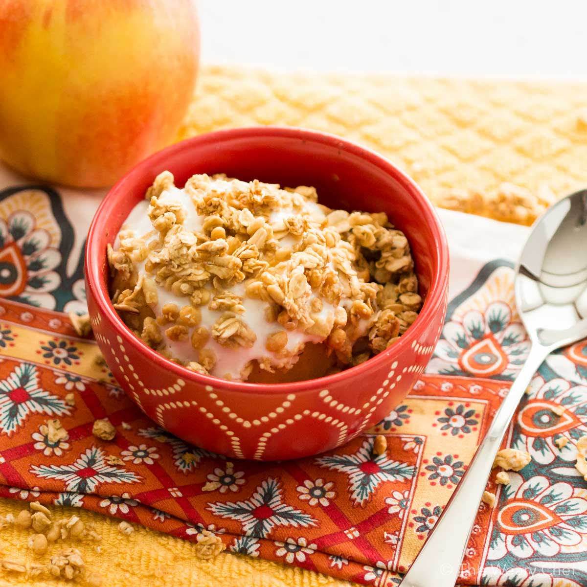 Treat yourself to a baked apple topped with creamy yogurt and crunchy granola, all ready in about five minutes with no added sugar!