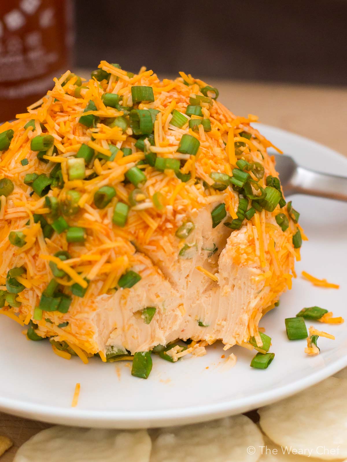 No party is complete without a cheese ball. Spice up your next gathering with this super simple Sriracha Cheddar Cheese Ball recipe. Your friends will thank you!