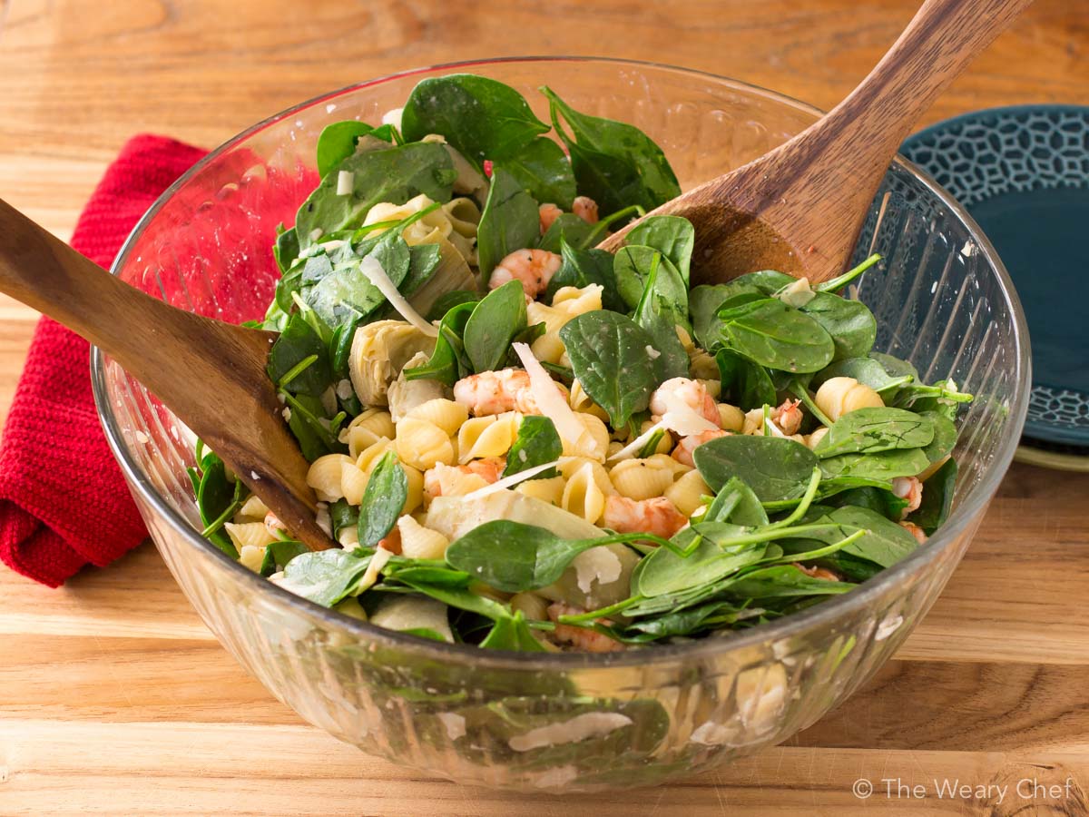 This shrimp pasta salad with spinach and artichokes is a perfect warm weather dinner or potluck dish! It's quick to make and can be served cold or slightly warm.