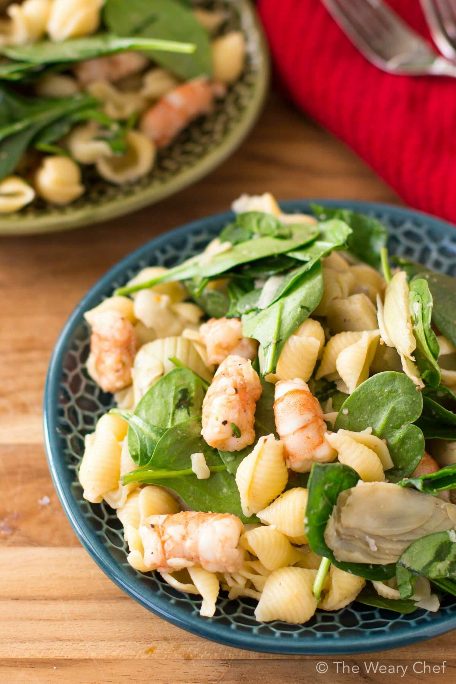 This shrimp pasta salad with spinach and artichokes is a perfect warm weather dinner or potluck dish! It's quick to make and can be served cold or slightly warm.