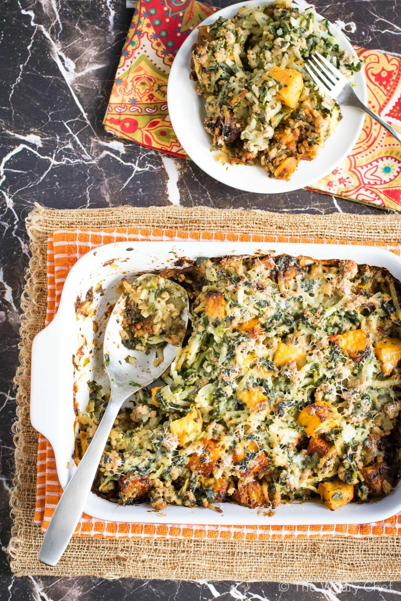 This hearty potluck casserole is loaded with seasoned ground turkey, butternut squash, spinach, and hashbrown potatoes. It all comes together with a creamy parmesan sauce. Sure to be a crowd favorite!