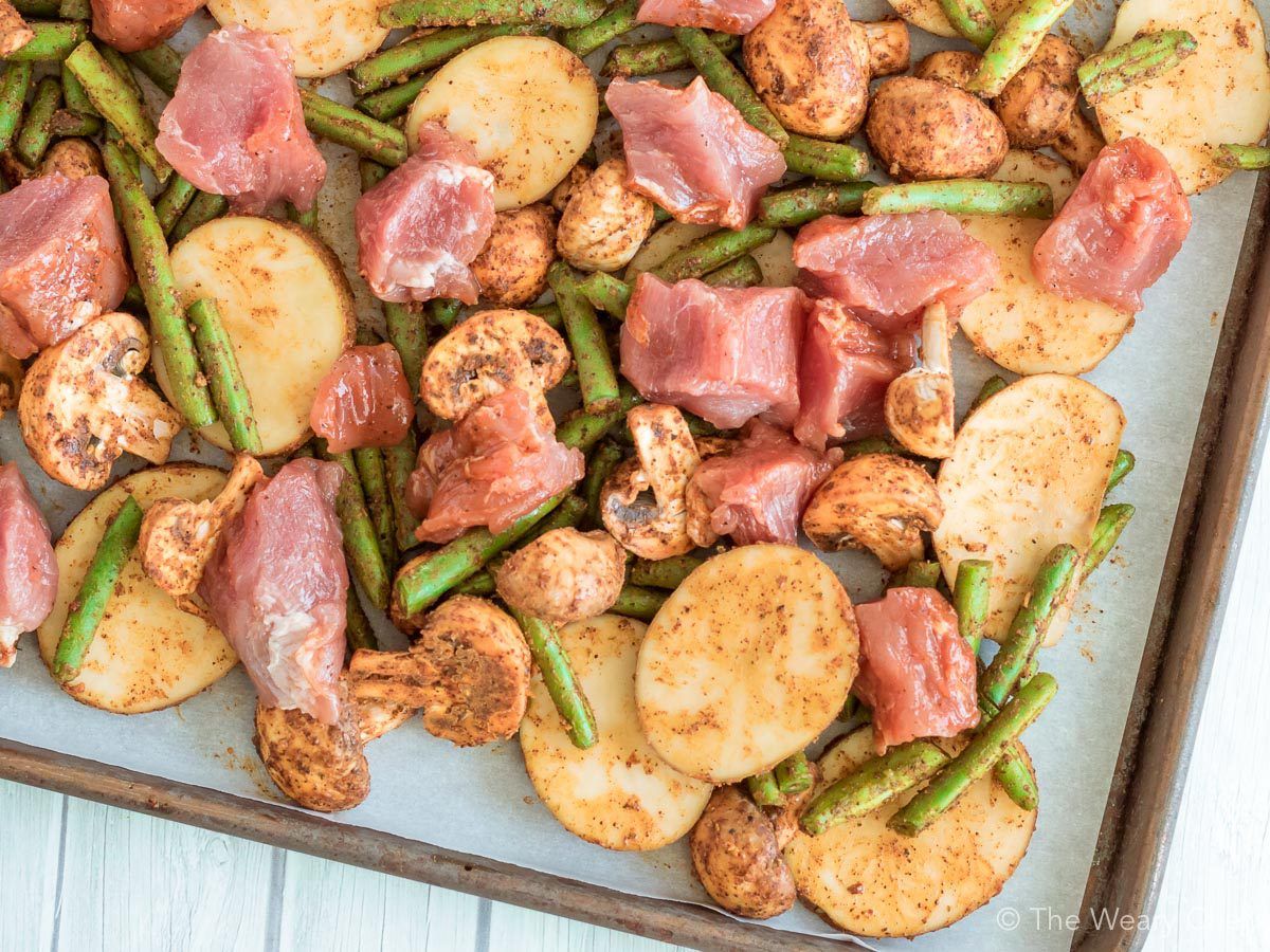 Tender fresh marinated pork, green beans, potatoes, and mushrooms come together in a perfectly easy sheet pan dinner.