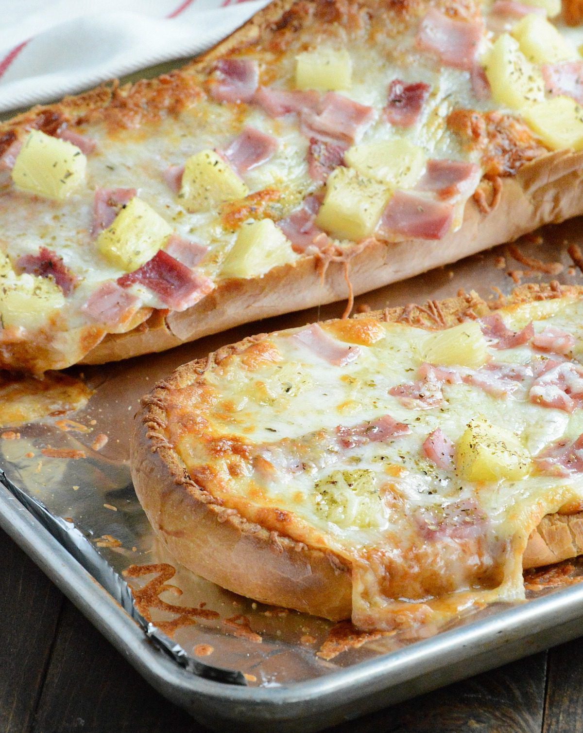 Hawaiian French Bread Pizza is super quick and easy, with the perfect balance of sweet, salty, and a little spicy. Your family will love it!