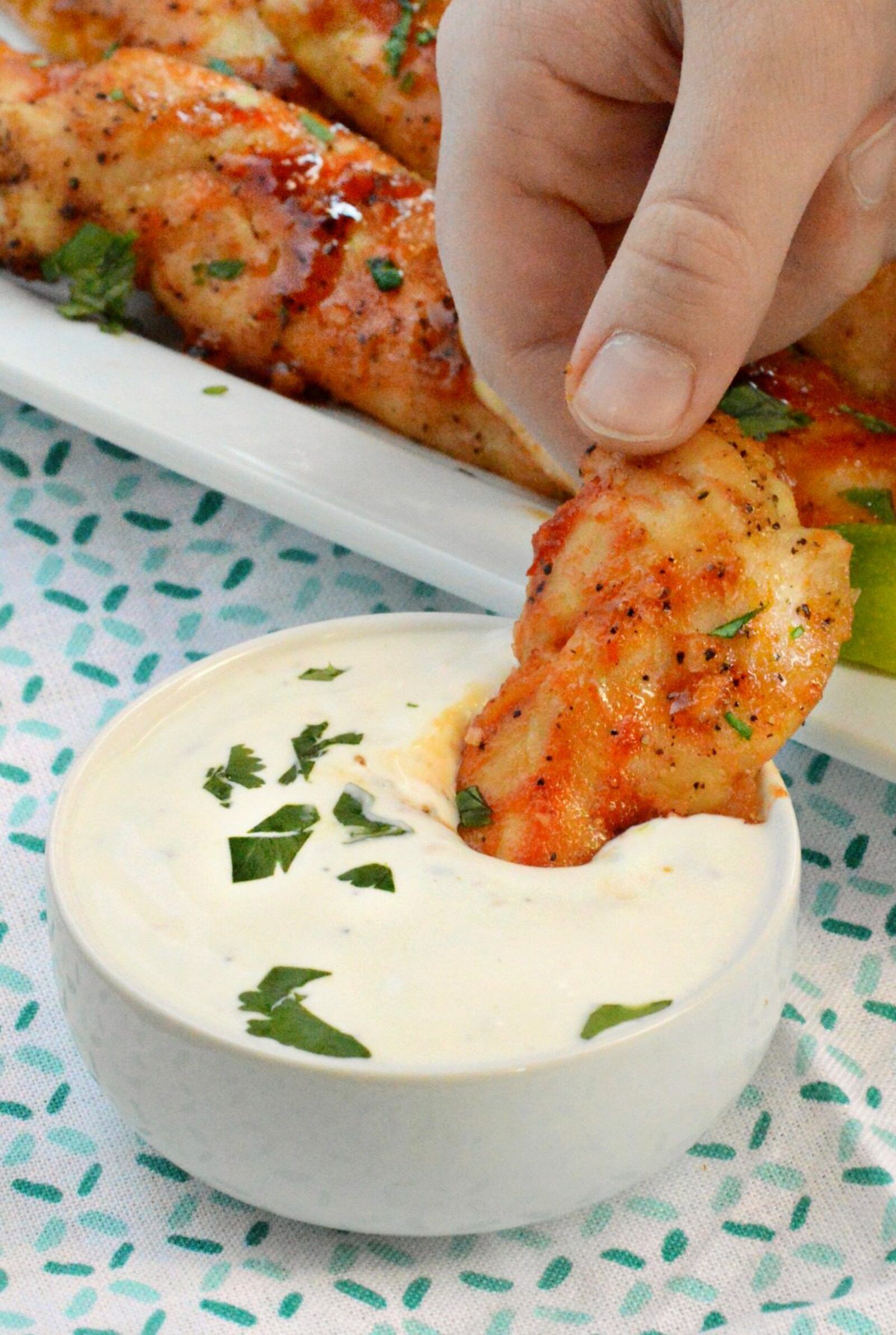 Honey Sriracha Chicken Tenders are a perfect family meal or game day snack. Serve them with homemade ranch for dipping!