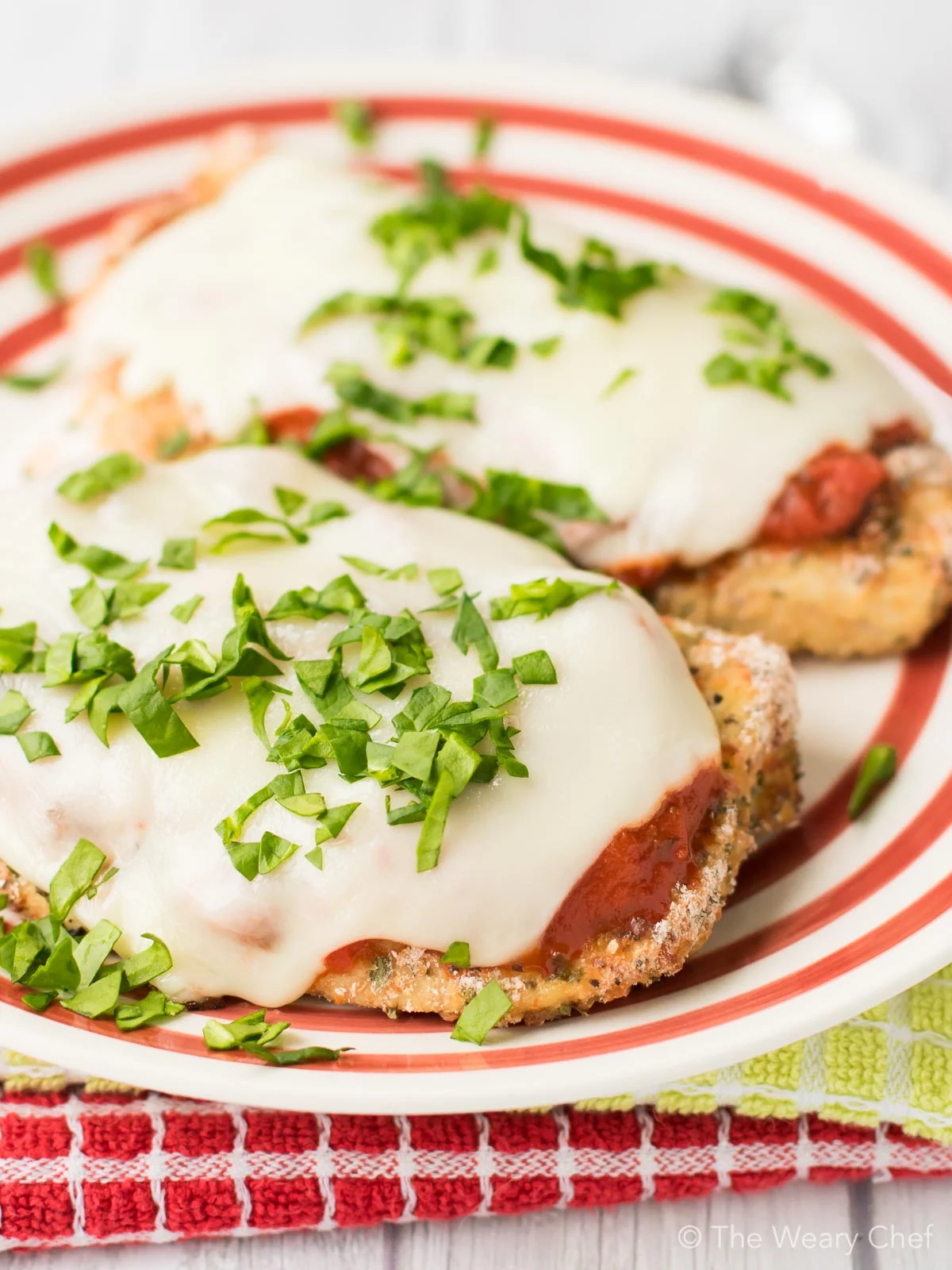 This Baked Chicken Parmesan is healthier, easier, and less messy than the classic version. Your family or guests will love this easy Italian dinner recipe!