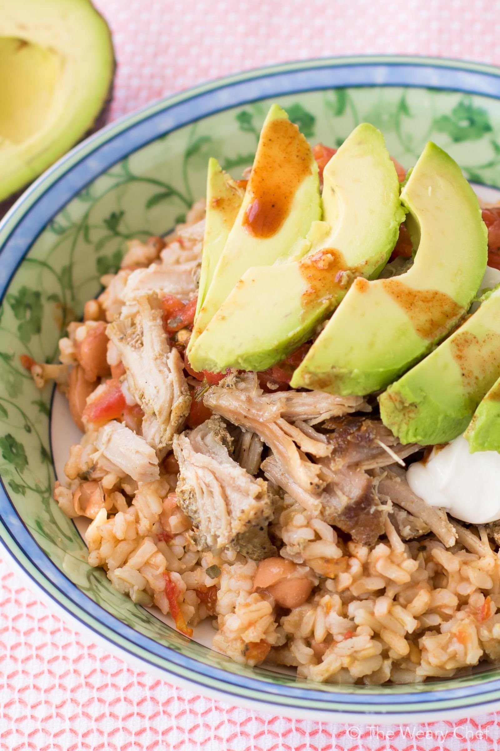 This very easy Mexican Pinto Beans and Rice topped with tender pork carnitas is delicious dinner the whole family will love! Prepare the pork in the slow cooker, and make the beans and rice in one pot in 15 minutes!