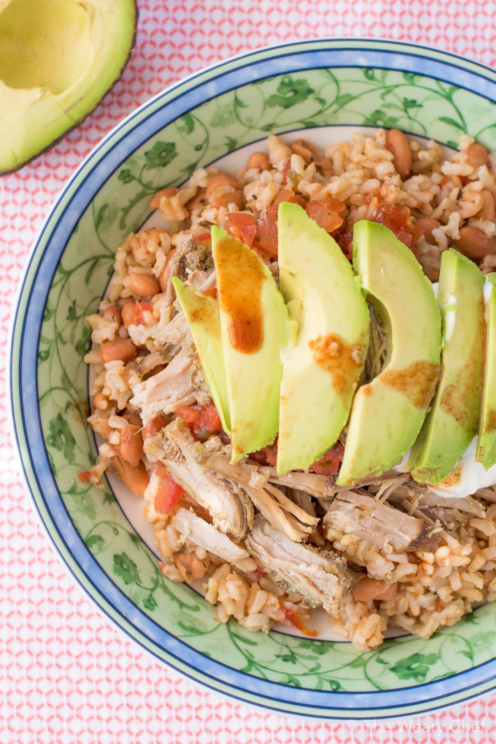 This very easy Mexican Pinto Beans and Rice topped with tender pork carnitas is delicious dinner the whole family will love! Prepare the pork in the slow cooker, and make the beans and rice in one pot in 15 minutes!