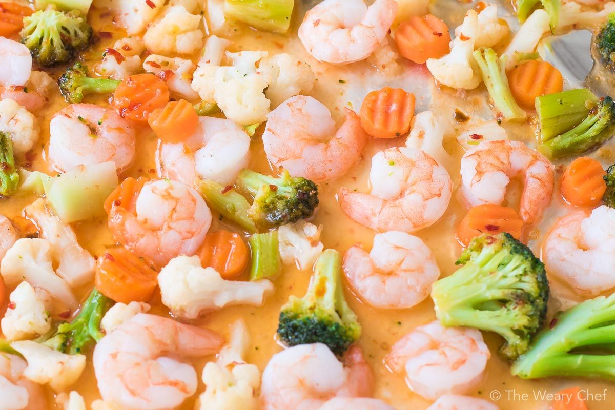 This 3-Ingredient Sweet Chili Shrimp Sheet Pan Supper could not be any easier! Just stir, cover, and bake. No thawing required!!