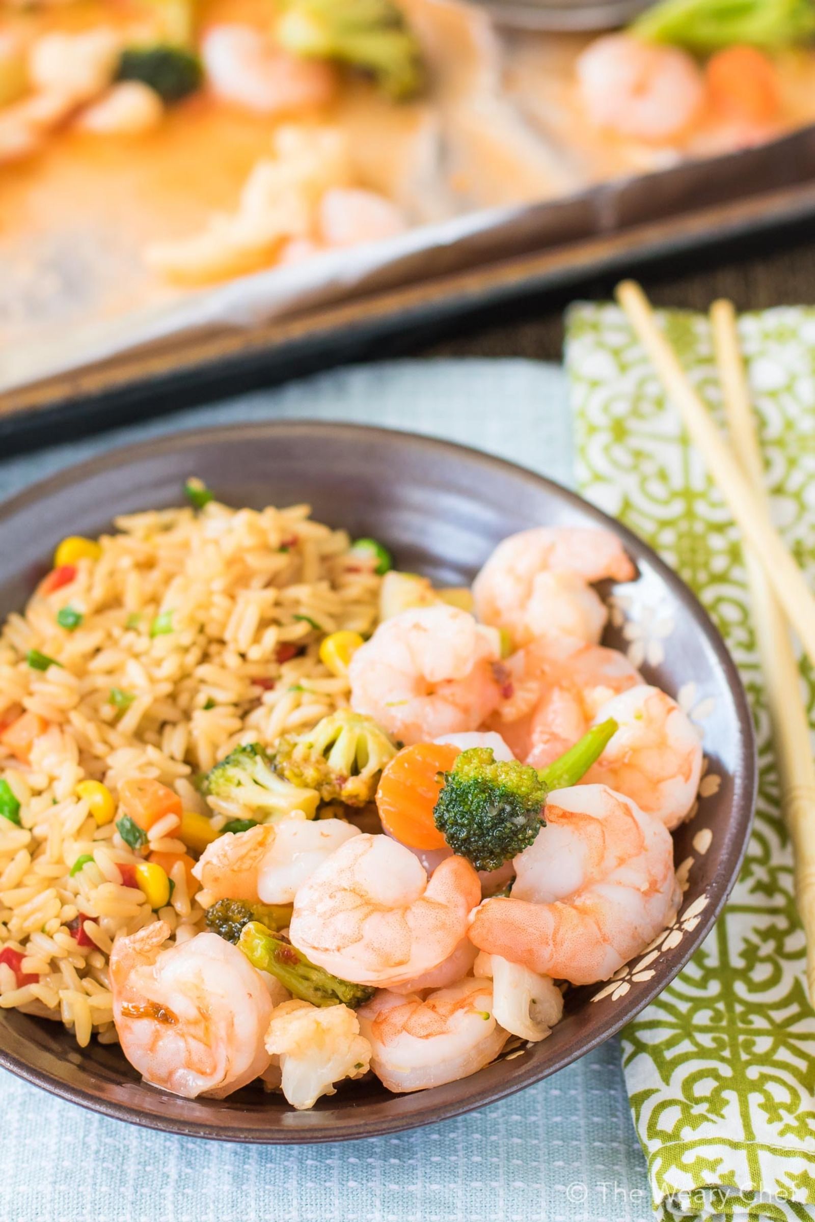 This 3-Ingredient Sweet Chili Shrimp Sheet Pan Supper could not be any easier! Just stir, cover, and bake. No thawing required!!