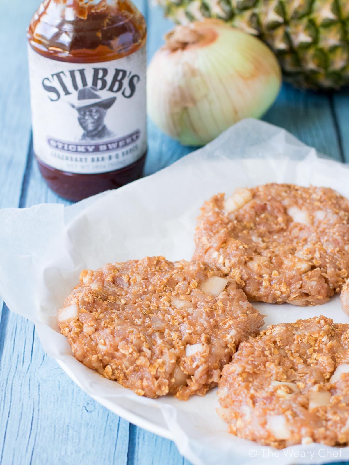 These sweet and savory Hawaiian Chicken BBQ Burgers will take your cookout to the next level! Seasoned chicken burgers are topped with sliced ham, melted cheese, a pineapple ring, and a generous drizzle of BBQ sauce. The flavor is out of this world!