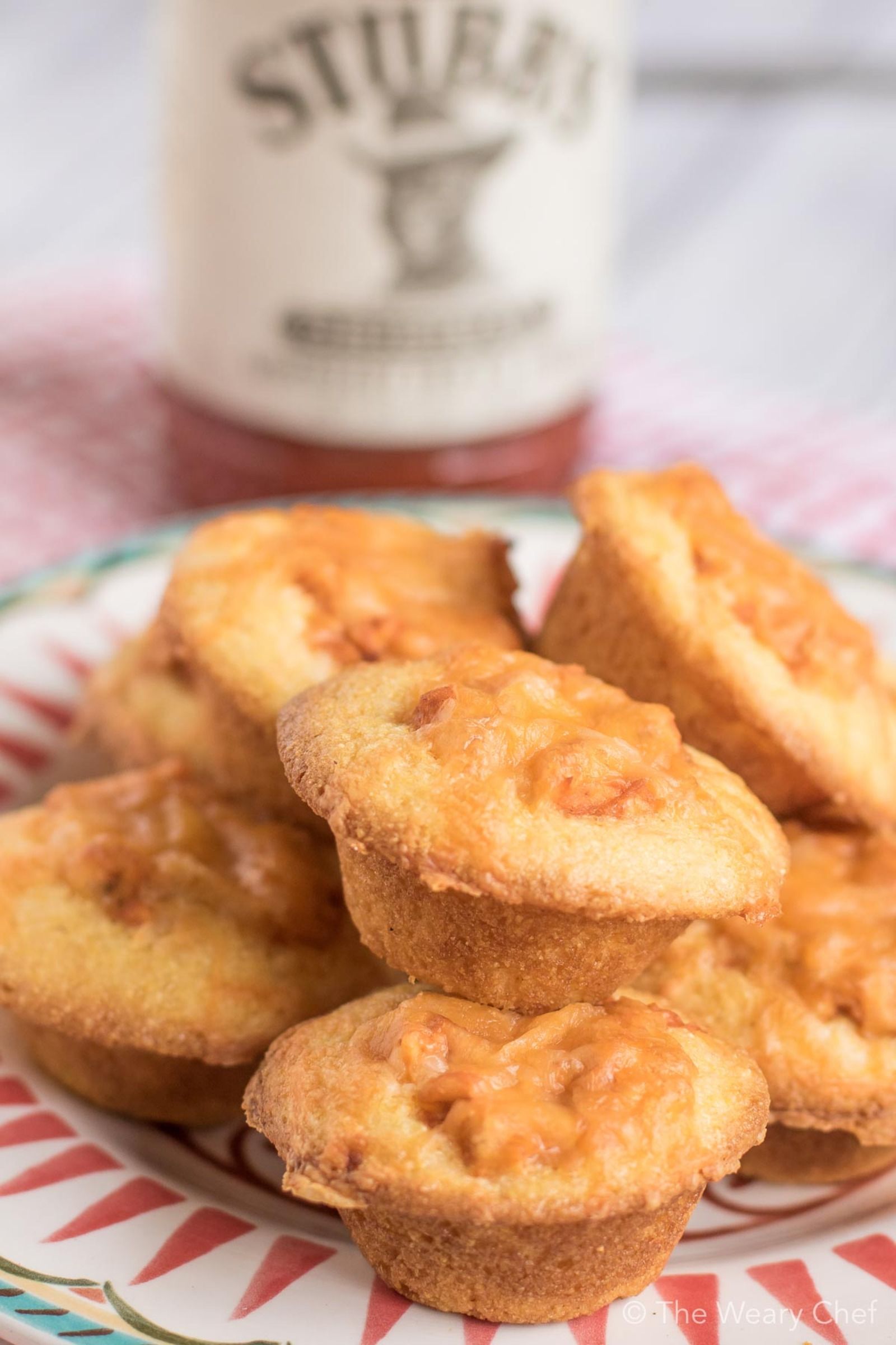 Mini cornbread muffins are stuffed with a creamy BBQ chicken mixture and topped with shredded cheese. Perfect easy recipe for tailgating, parties, and potlucks! #bbq #chicken #recipe