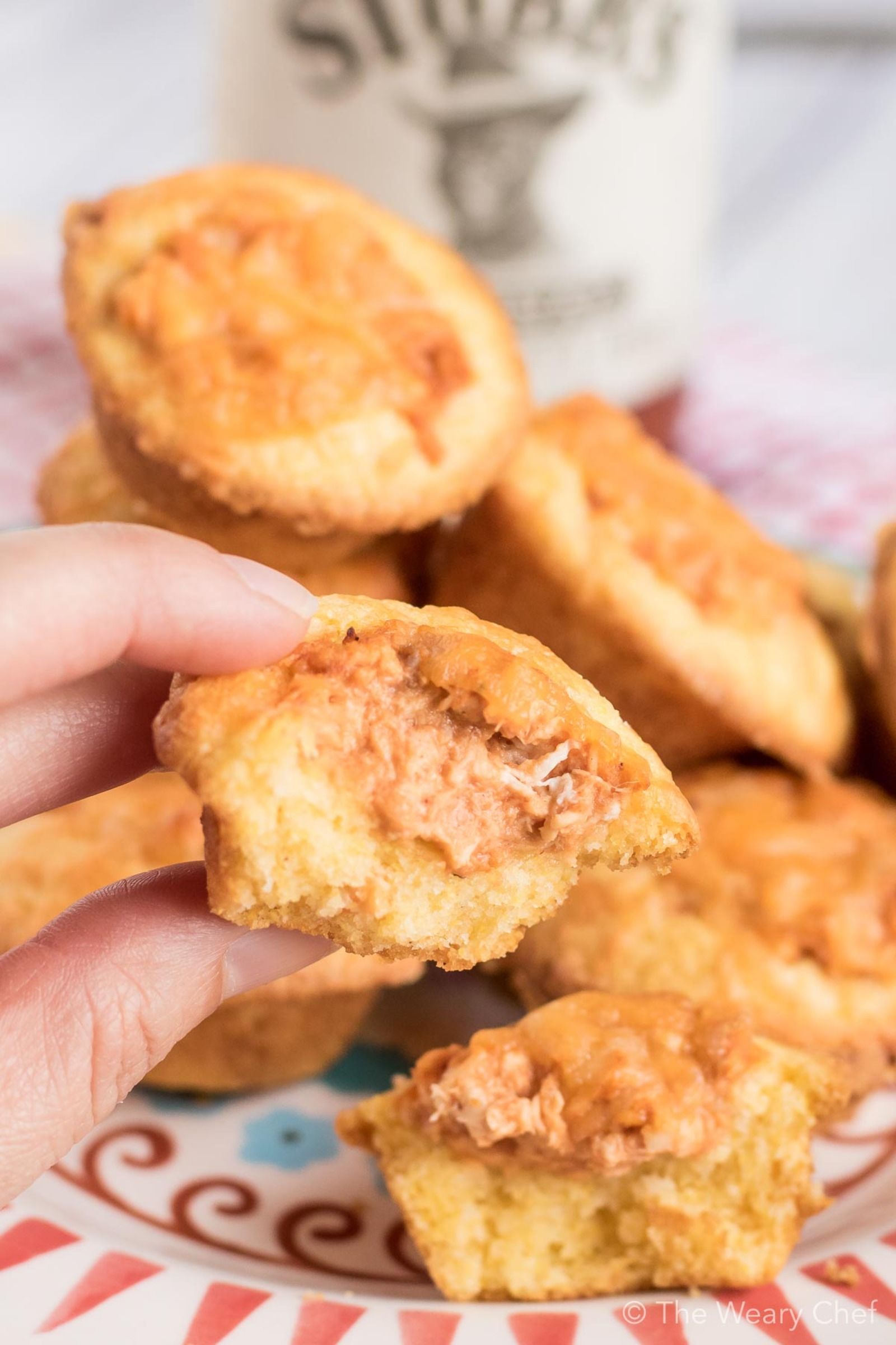 Mini cornbread muffins are stuffed with a creamy BBQ chicken mixture and topped with shredded cheese. Perfect easy recipe for tailgating, parties, and potlucks! #bbq #chicken #recipe