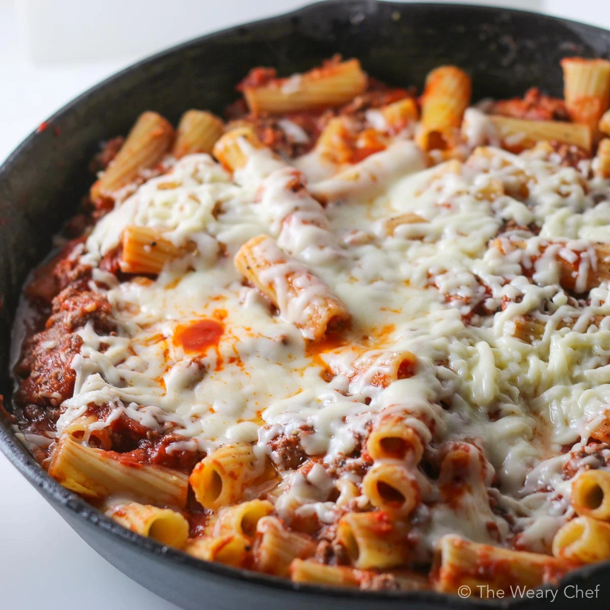 This cheesy skillet pasta is loaded with hearty beef, homemade tomato sauce, and plenty of mozzarella cheese. It is sure to be a favorite dinner recipe in your kitchen! #pasta #skillet #cheese #comfortfood