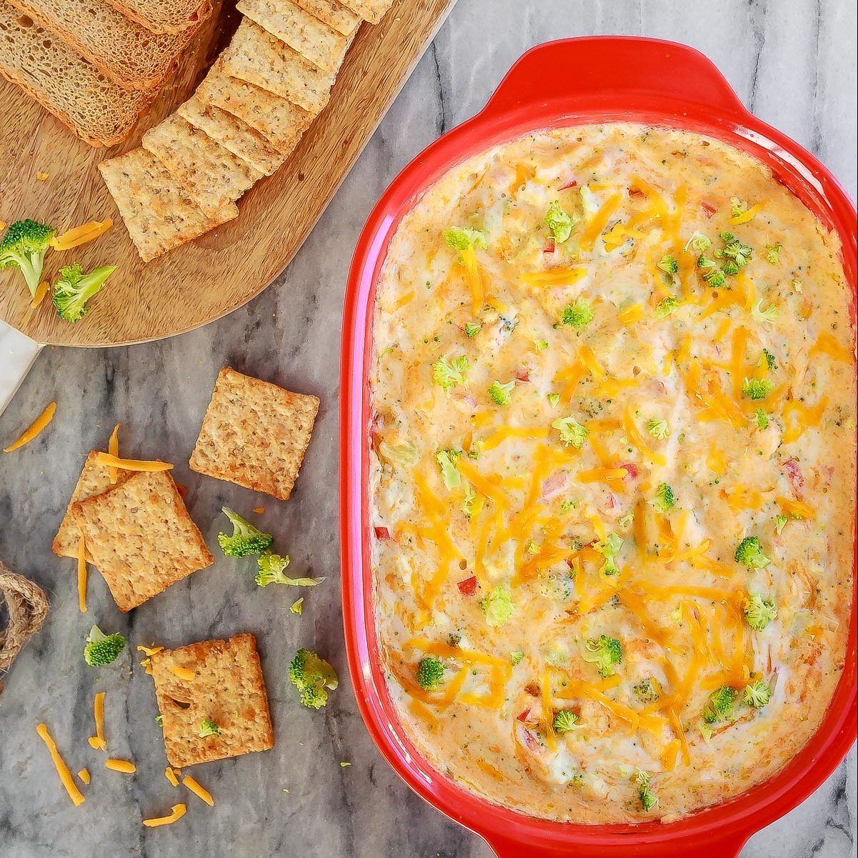 This hot, baked broccoli cheese dip is easy to mix up and can be made ahead of time. Everyone will love this appetizer served with crackers, chips or veggies! #dip #broccoli #cheese #cheddar #appetizer