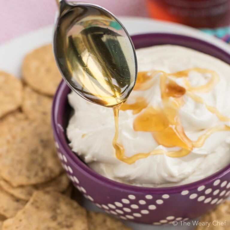 Looking for an easy appetizer to serve at your next party? This Honey Whipped Goat Cheese Spread is IT! All you need is tangy chevre, rich cream cheese, and sweet raw honey. #honey #chevre #goatcheese #cheesedip #appetizer