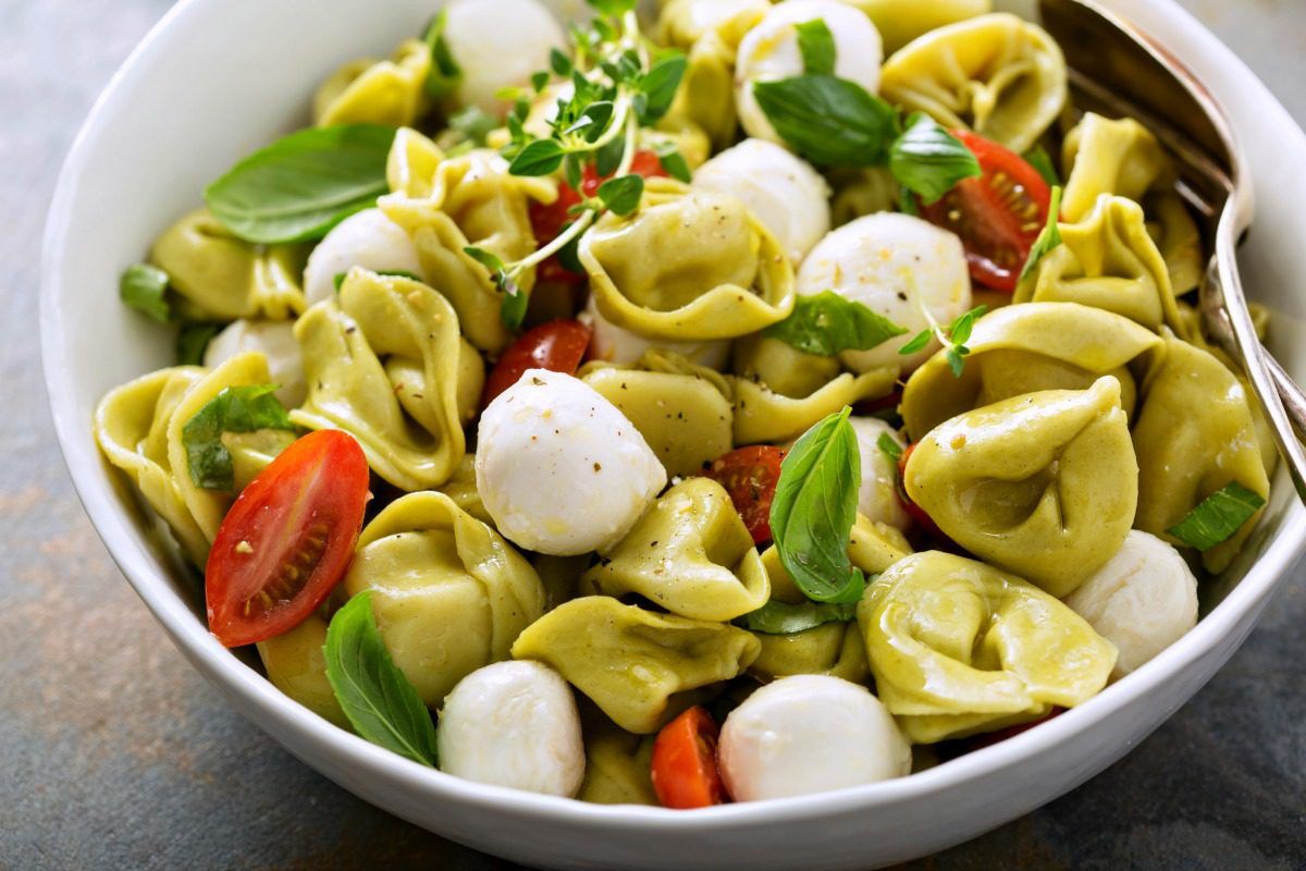 This fresh, easy, and filling Tortellini Pasta Salad with Caprese flavors makes a quick dinner or side dish! #tortellini #pastasalad #vegetarian