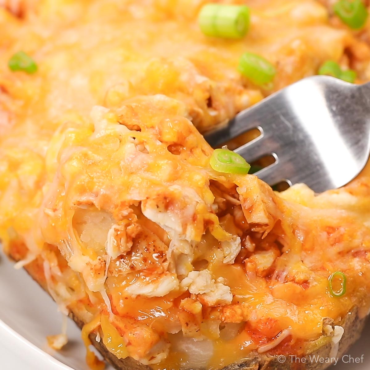 Cheesy Buffalo Chicken Stuffed Potatoes are a flavorful meal that comes together quickly. They are a perfect way to enjoy leftover or rotisserie chicken! #buffalochicken #bakedpotato #stuffedpotato #spicy