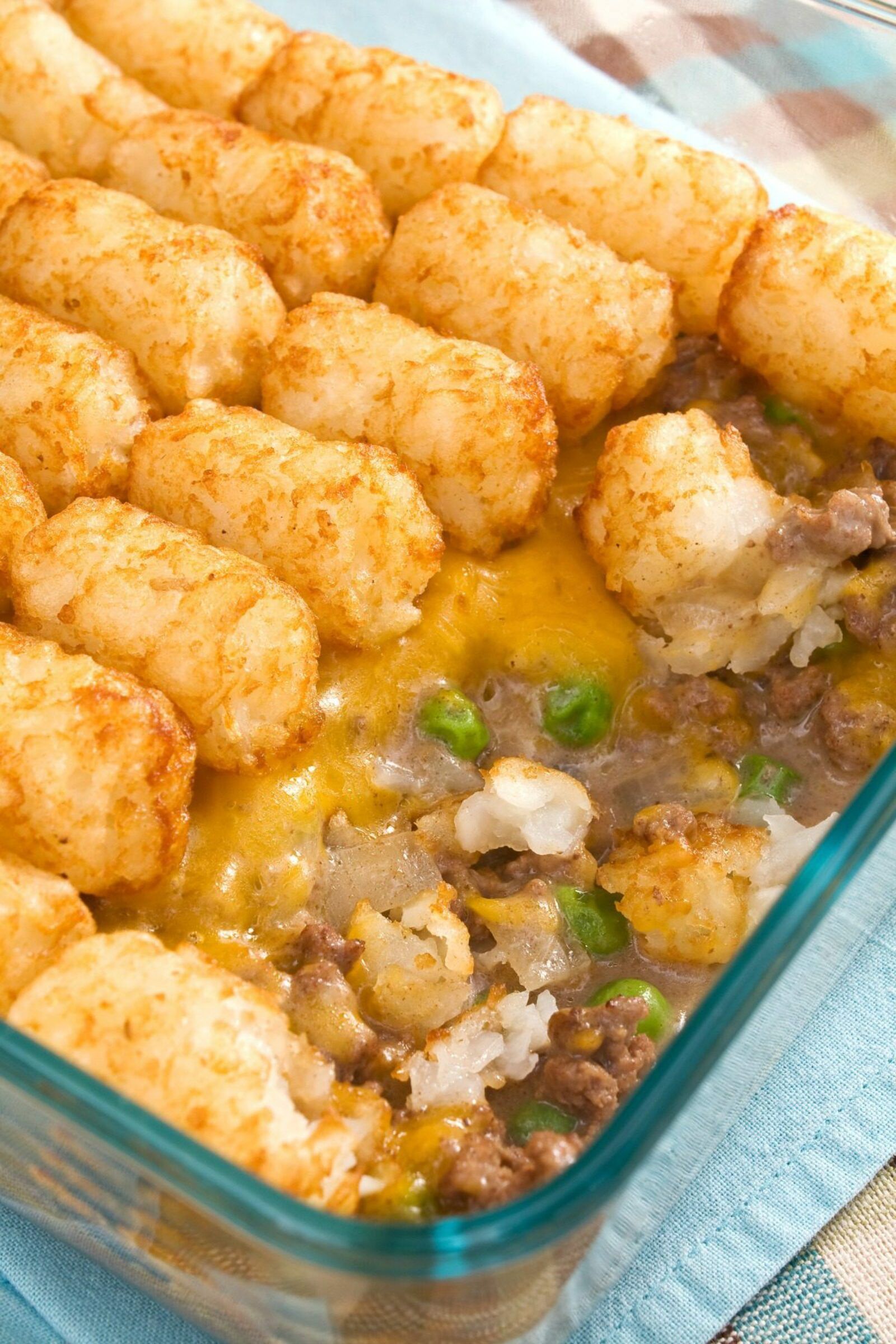 This easy Tater Tot Hot Dish is a perfect family dinner or potluck favorite. A hearty filling is topped with crispy tater tots for a truly comforting meal. #hotdish #casserole #tatertots