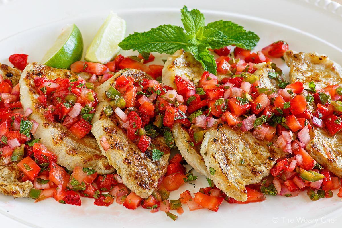 Marinated and grilled pork loin chops are topped with fresh strawberry salsa bursting with mint and jalapeño flavors.