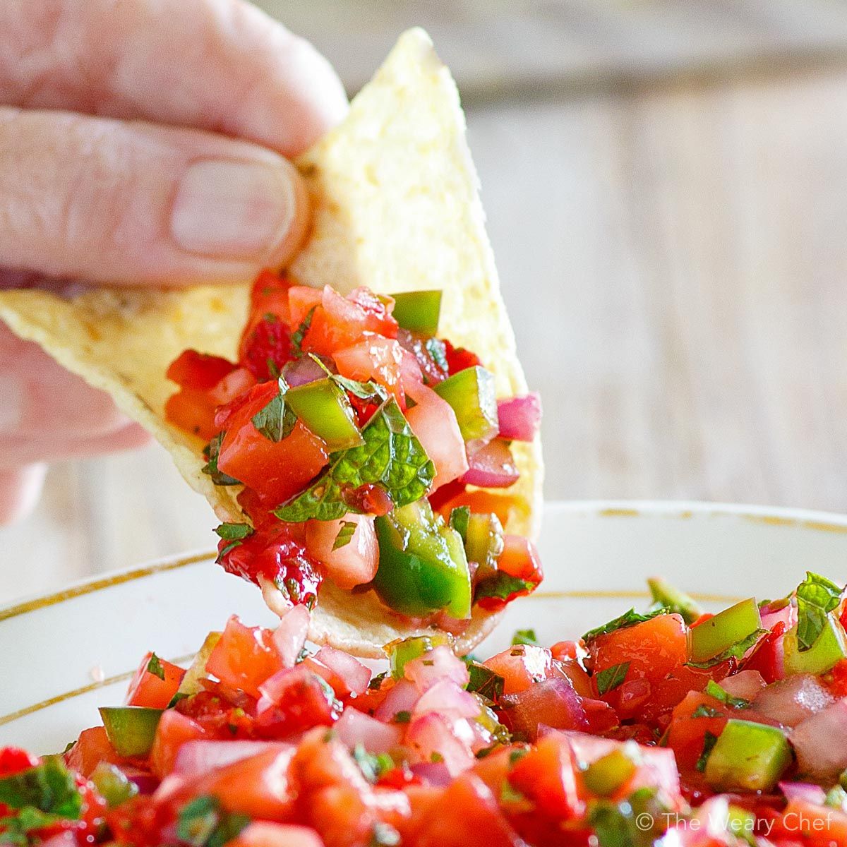 Marinated and grilled pork loin chops are topped with fresh strawberry salsa bursting with mint and jalapeño flavors.