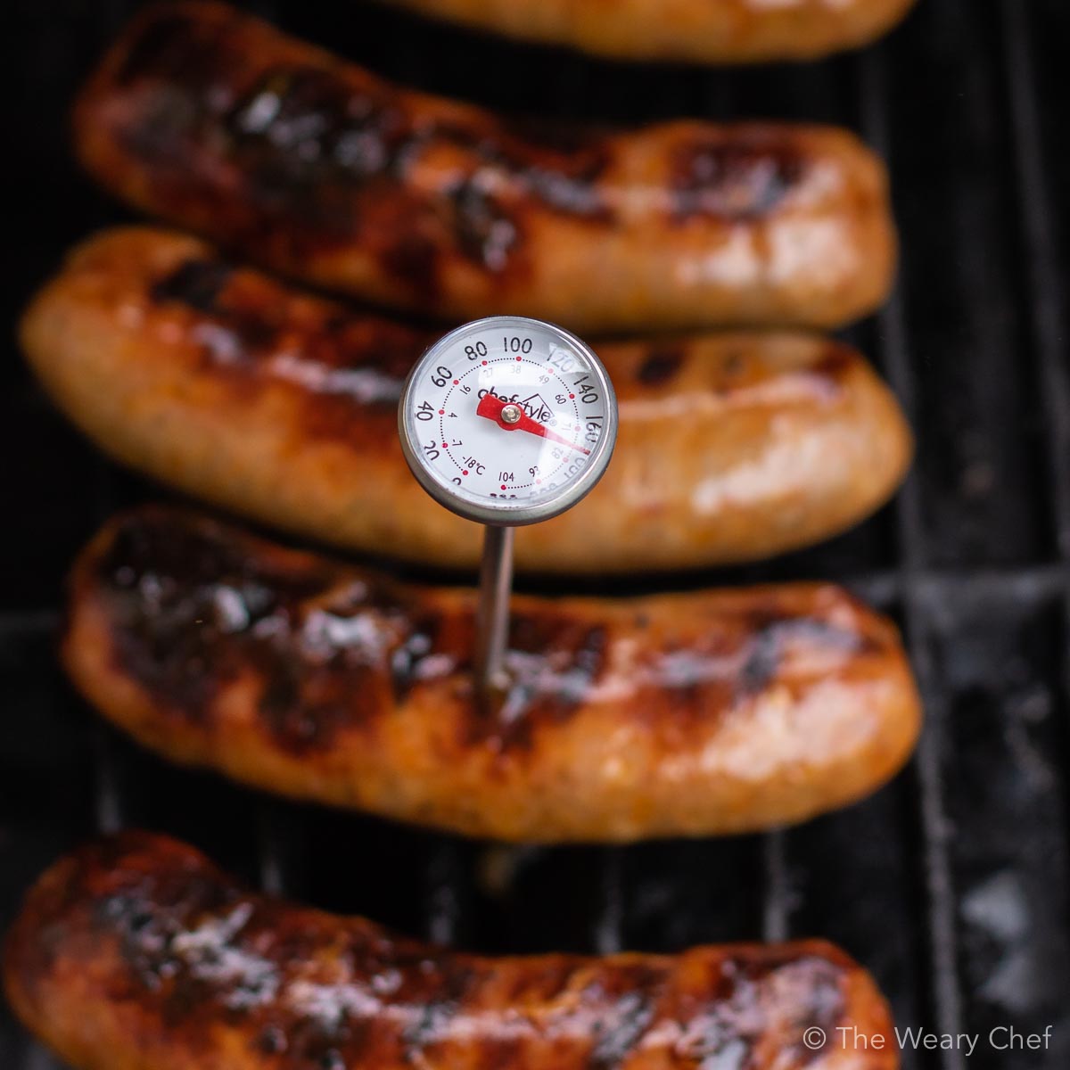 Grilled Sriracha Peppers and Onions with Sausages are an easy meal for summer entertaining! #grill #sausage #sriracha #spicy #peppers #thewearychef