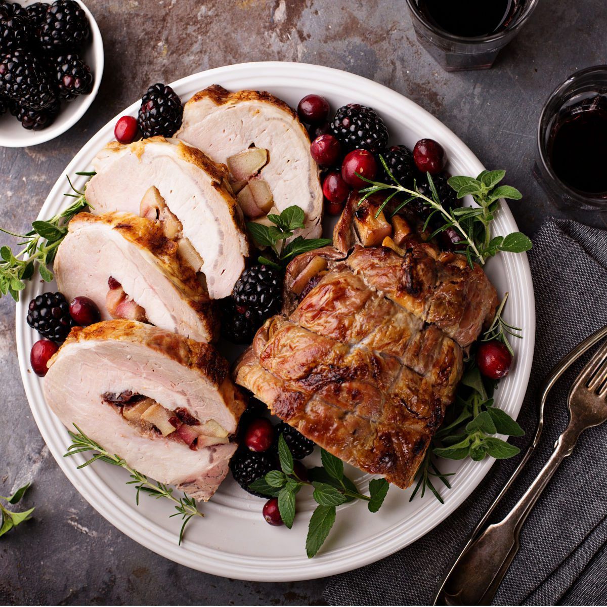 This beautiful Apple Cranberry Stuffed Pork Tenderloin only needs a few ingredients and is perfect for holiday meals. #pork #cranberry #apple #dinnerrecipe #holidayrecipe