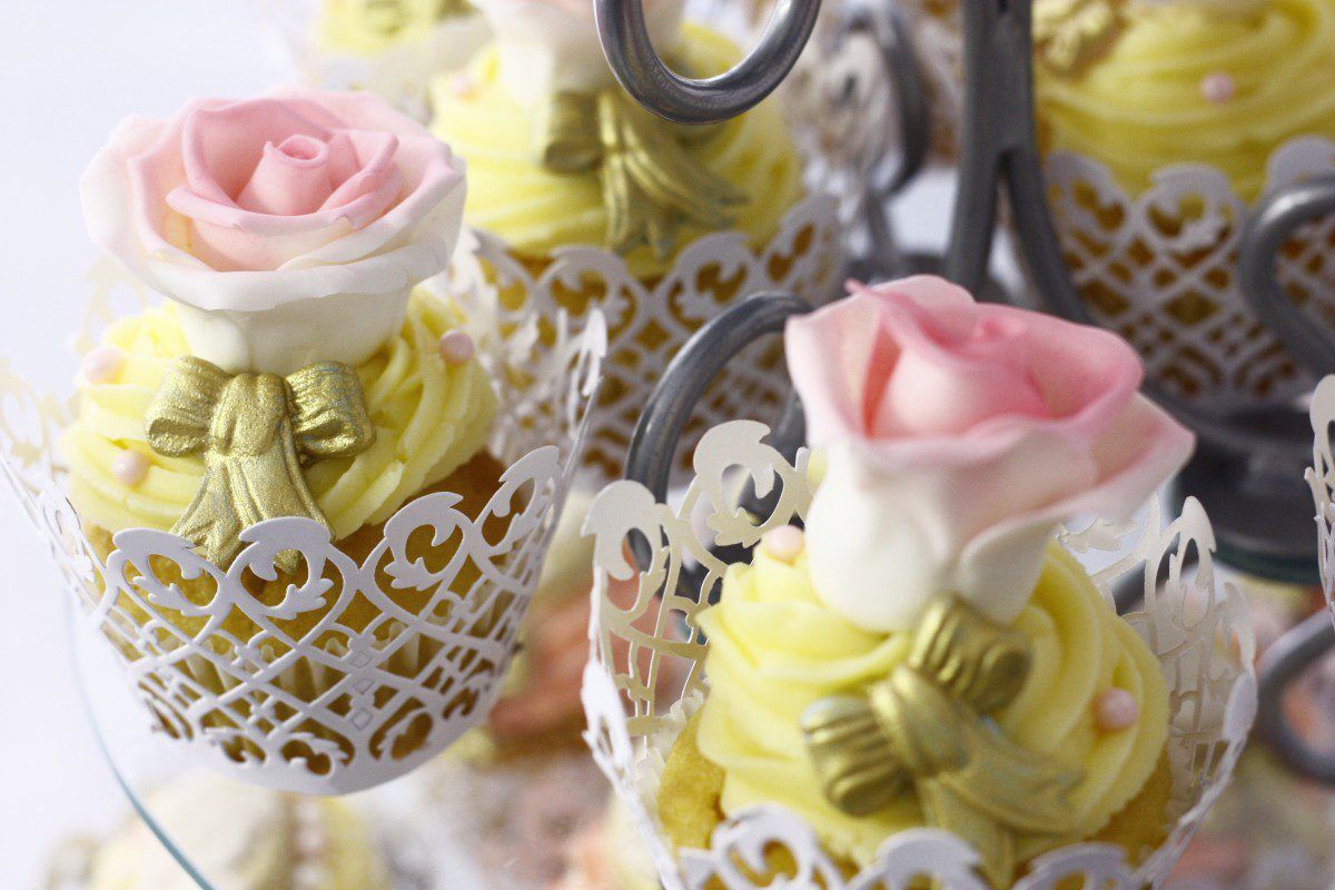 rose-topped cupcakes in lacy cups