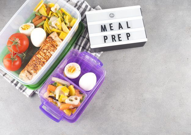 board with meal prep inscriptions near  food in containers