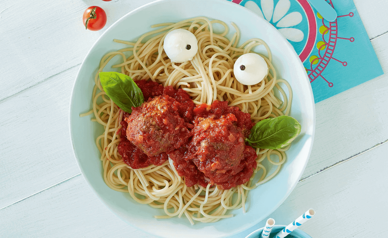 Meatballs and spaghetti on a plate with a funny face shape
