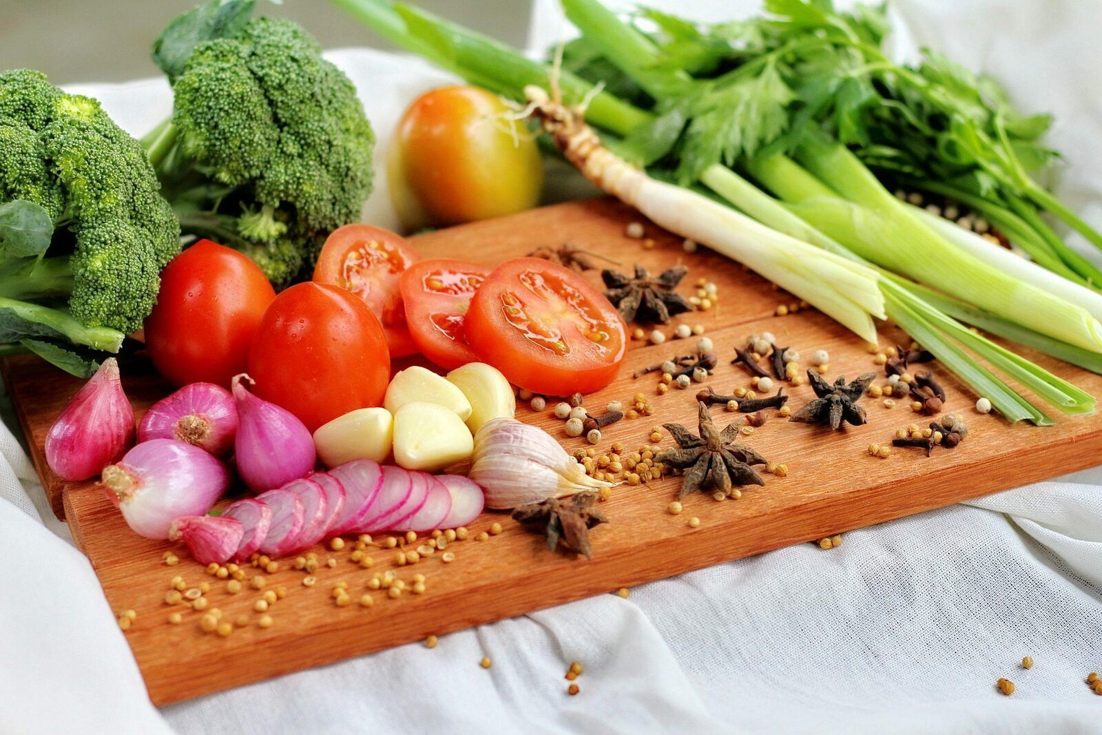 A cutting board with a variety of vegetables