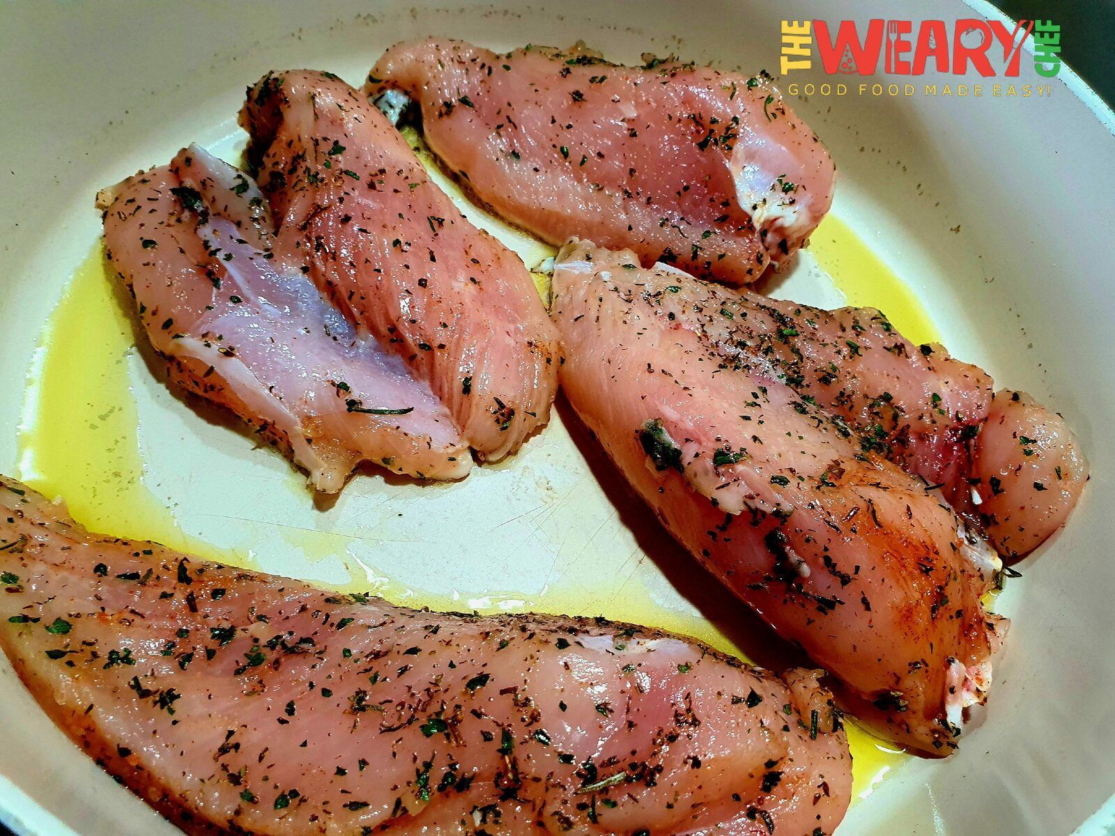 chicken breasts with herbs in pan
